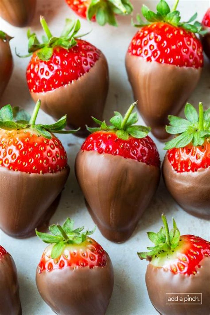 When should you cover strawberries with straw